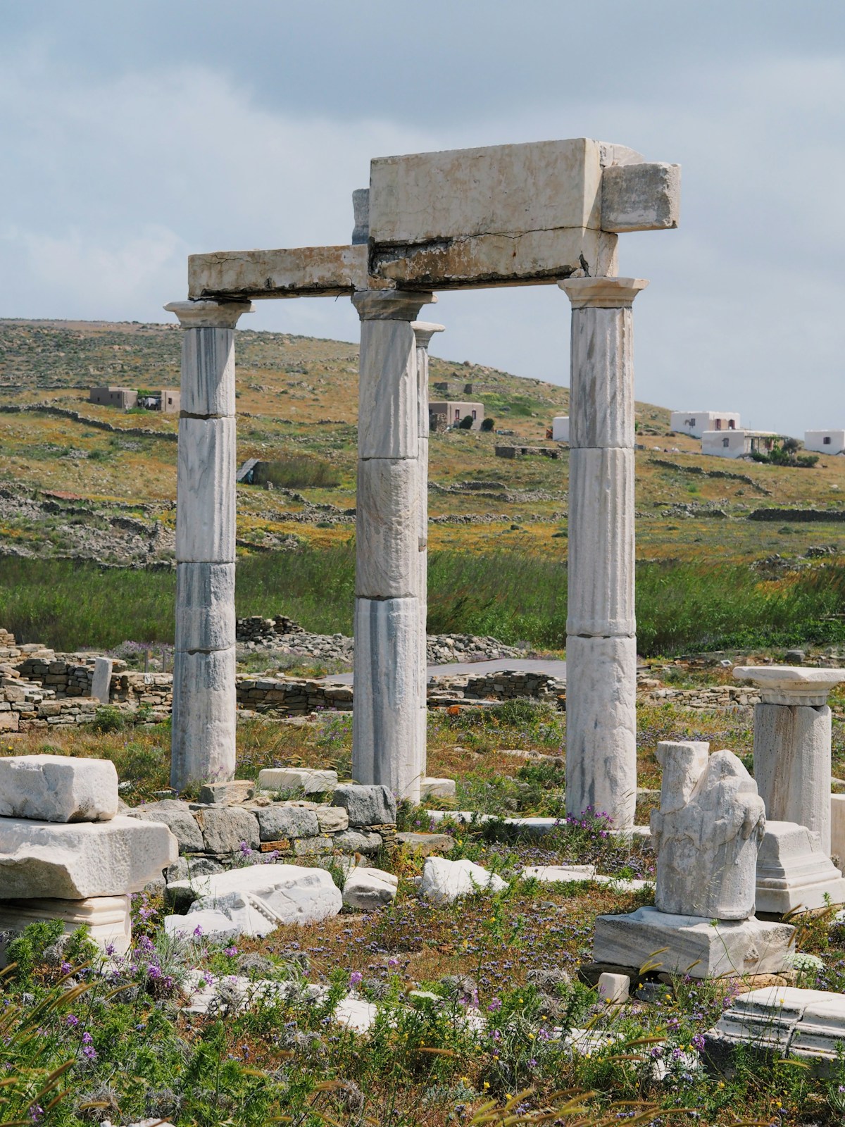 The stone Treasury of the Athenians at Delphi with the mountain landscape behind