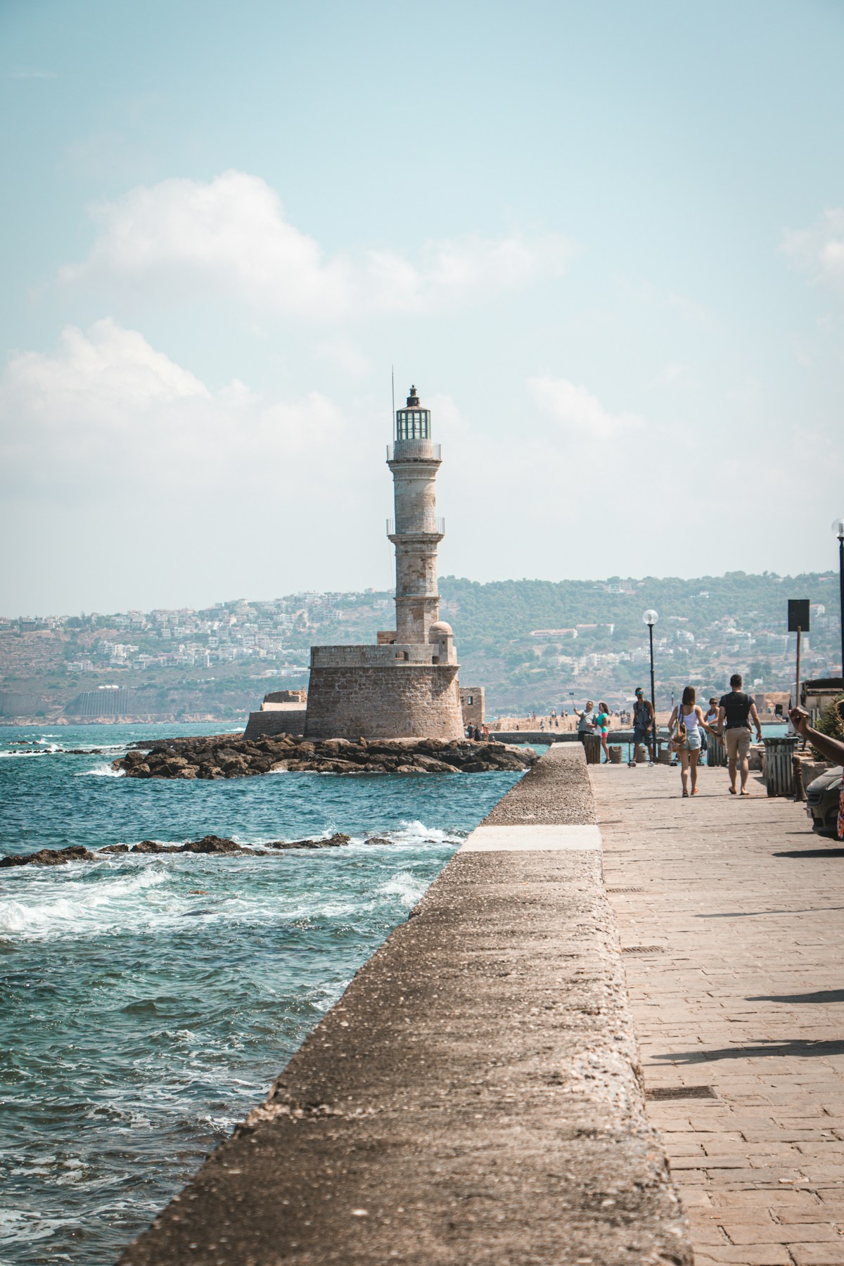 The Venetian Koules fortress lighthouse at Heraklion harbour, with the city and hills behind
