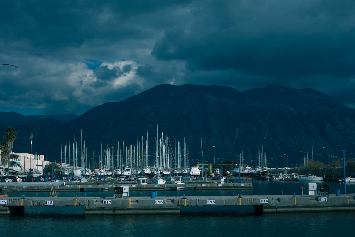 The harbour waterfront of Kalamata with fishing boats and the Taygetos mountains behind
