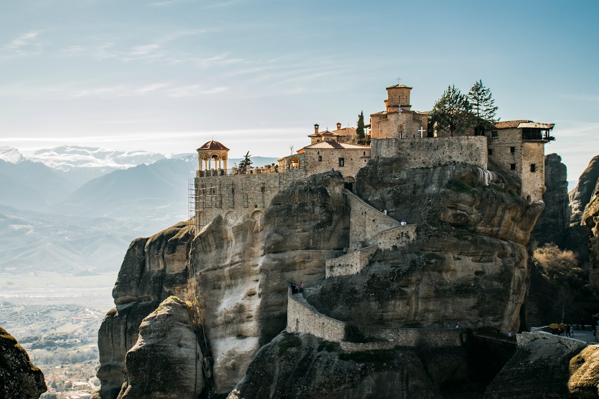 The monasteries of Meteora perched on towering rock pillars at sunset