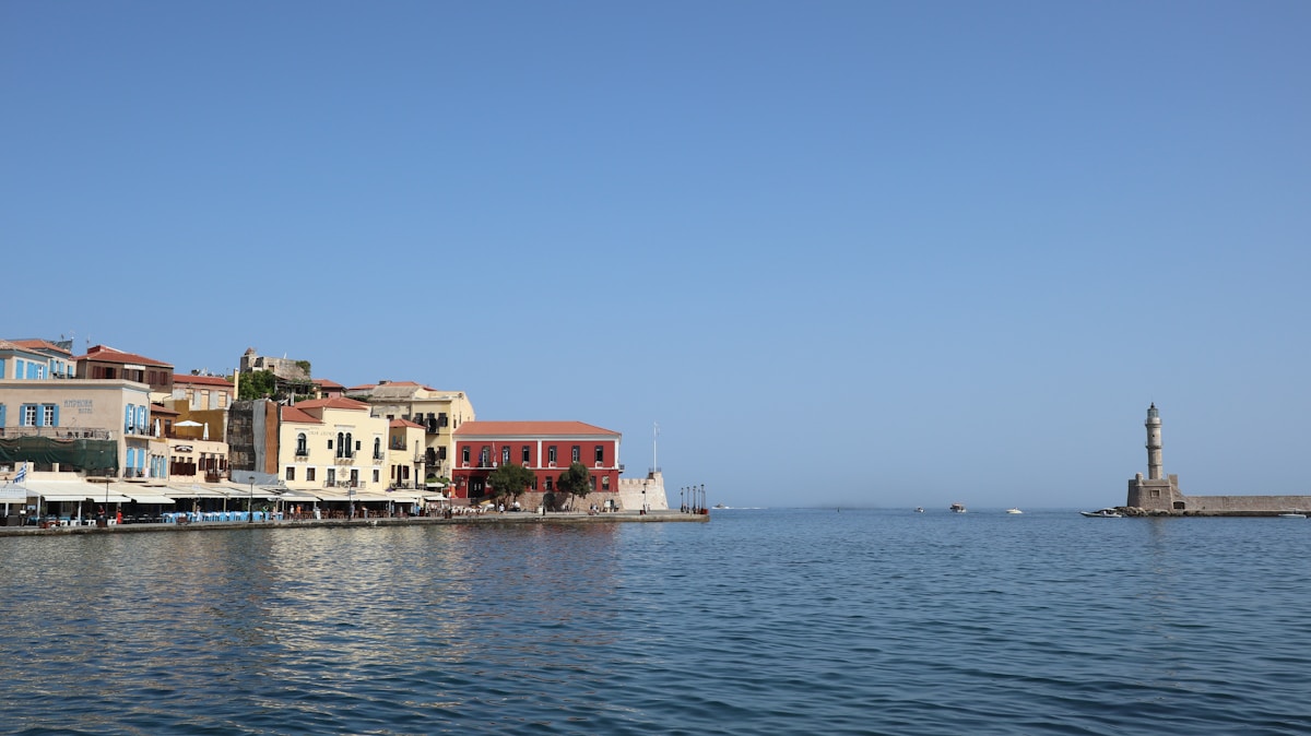 Venetian harbour of Chania with colourful waterfront buildings and the Egyptian lighthouse at the end of the breakwater