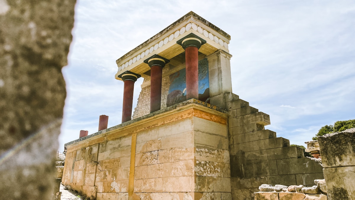 The North Entrance to the Palace of Knossos with reconstructed red columns and Minoan bull relief fresco, Crete, Greece