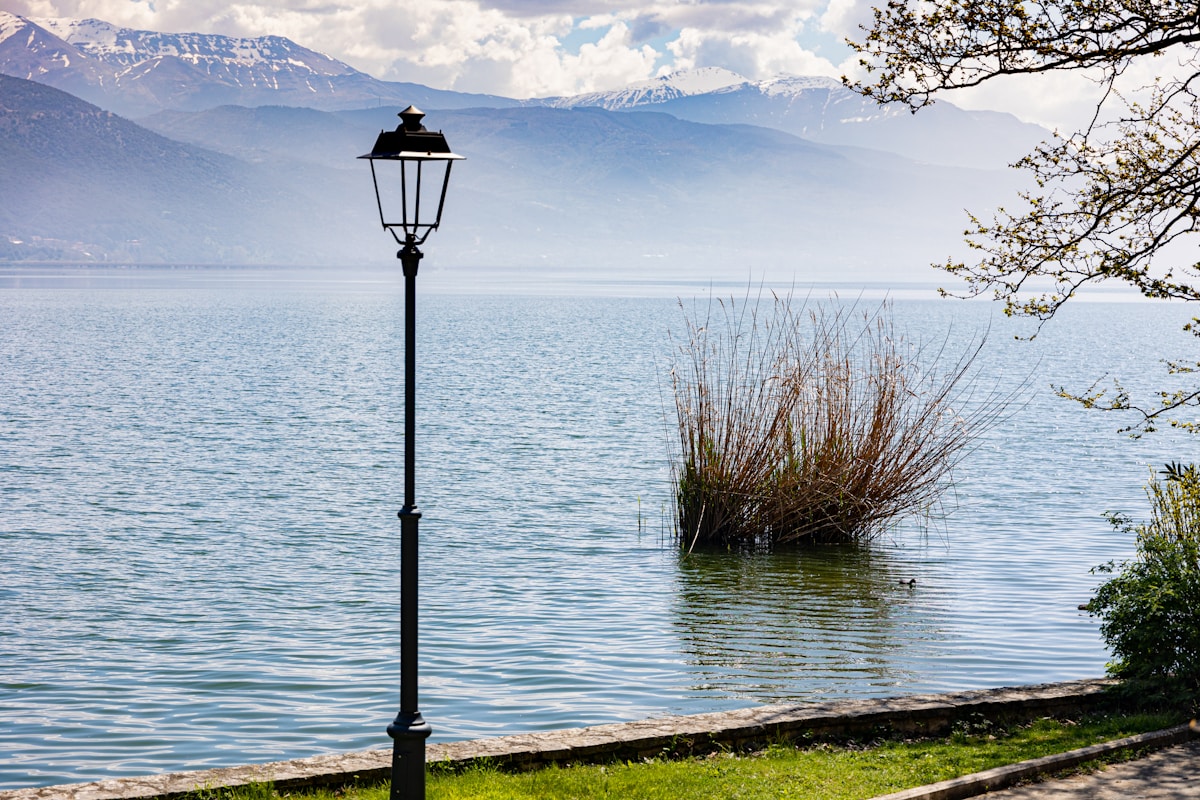 Lamp post next to the water at dusk, Ioannina, Greece