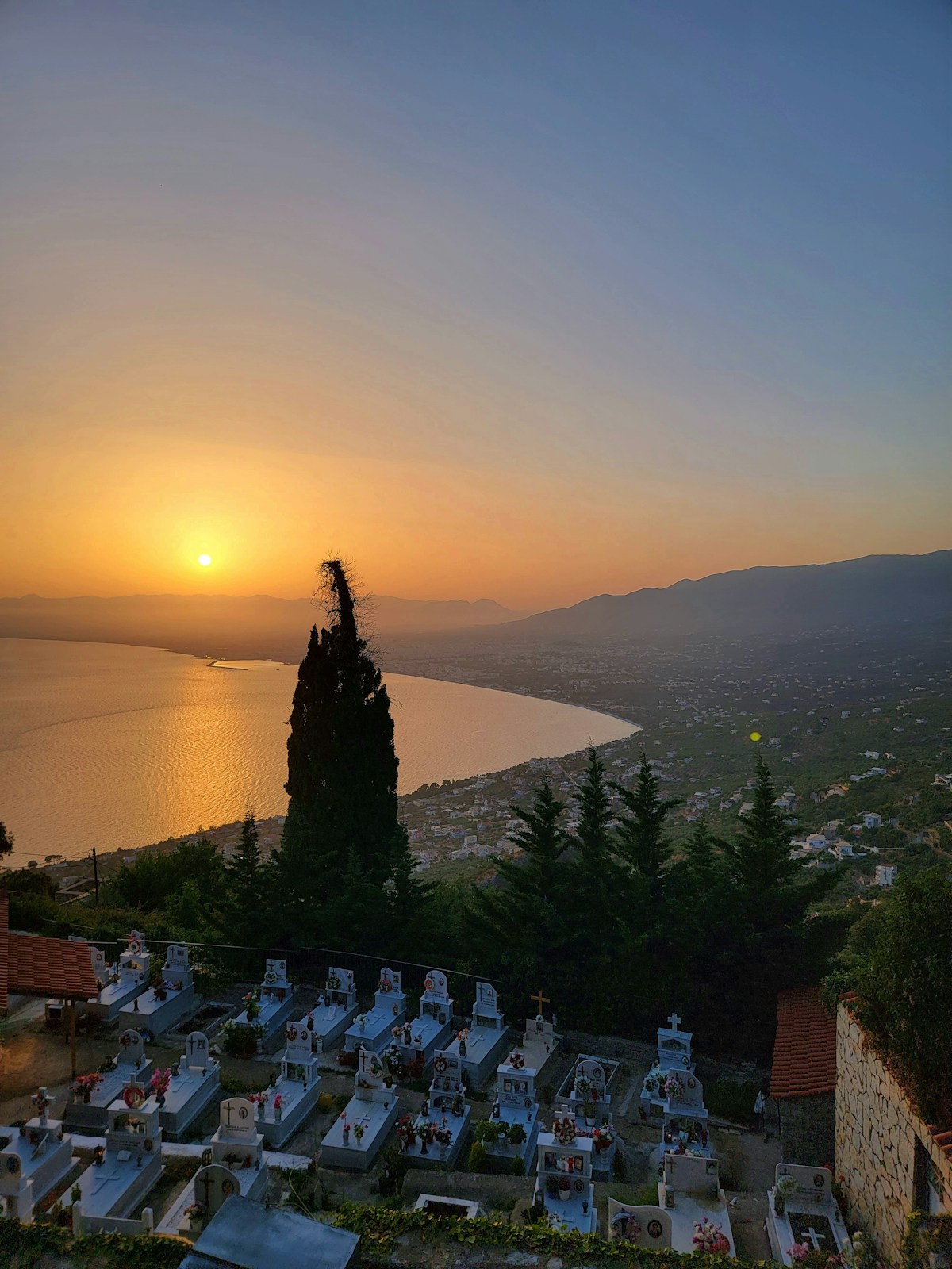 Sunset view over the Kalamata waterfront with hills in the background, Greece