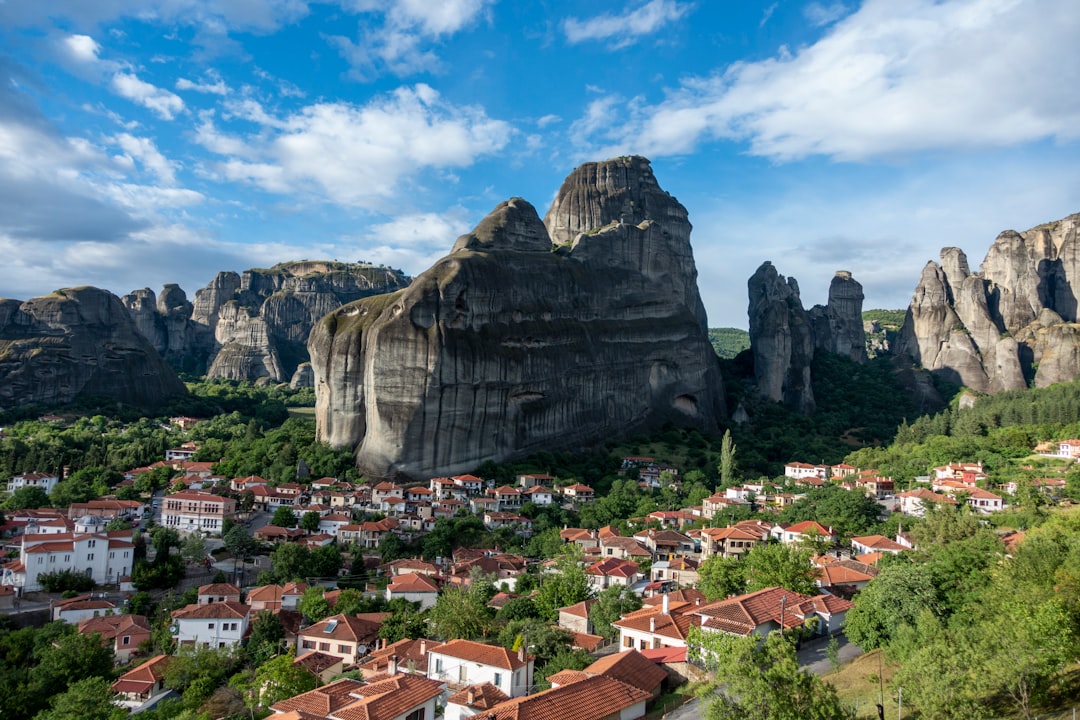 The village of Kastraki with red-roofed houses spread below the towering sandstone pillars of Meteora, central Greece