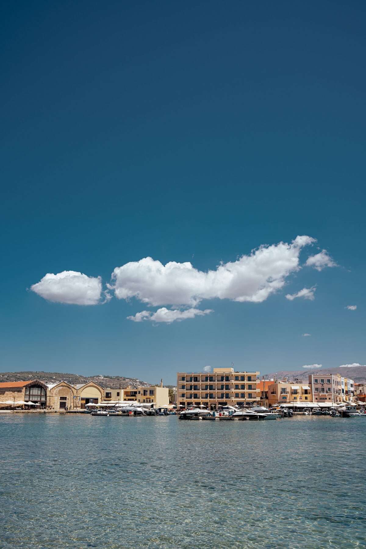 Peaceful view of Heraklion harbour with calm turquoise water, Crete, Greece