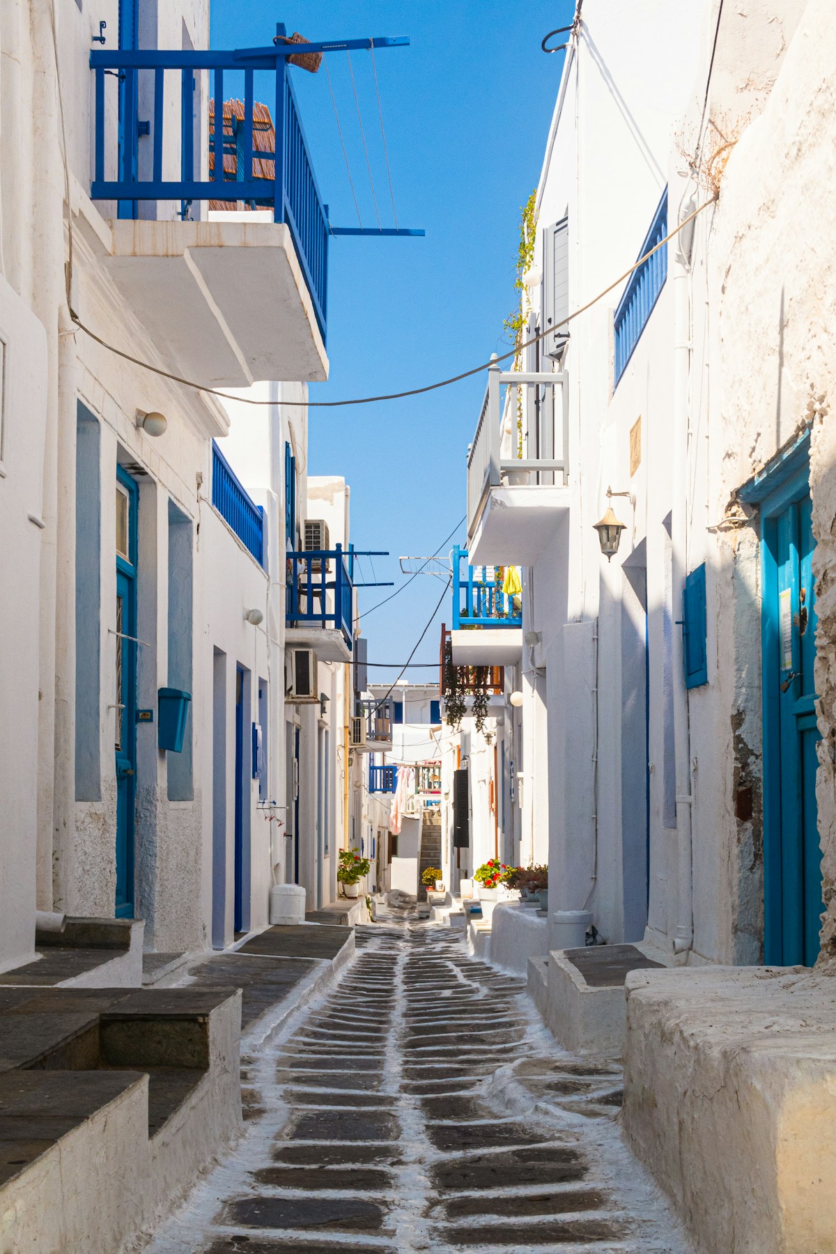 Blue and white concrete building on a sunny street, Mykonos, Greece