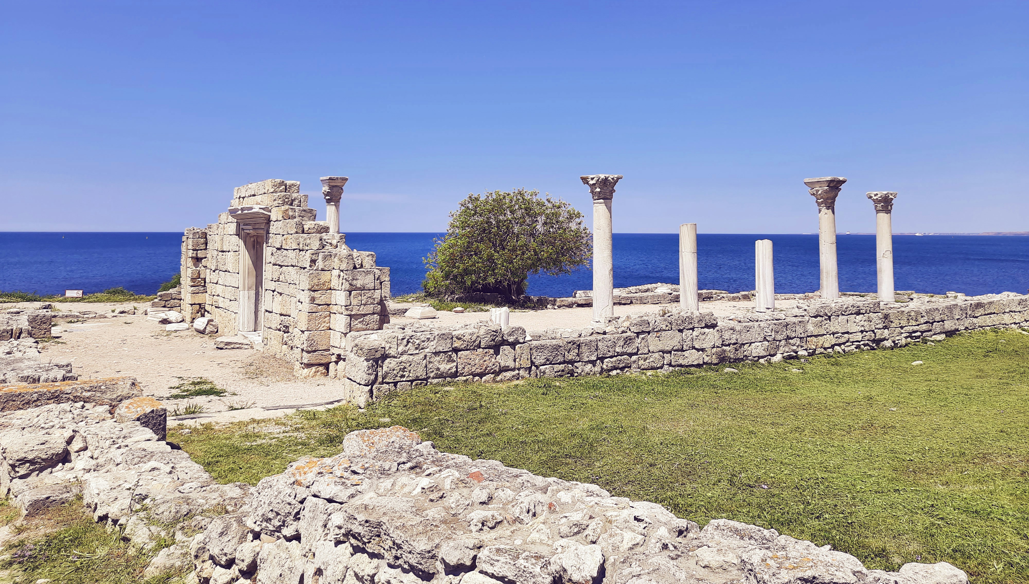 The famous stone lions of the Terrace of Delos with the Aegean Sea in the background