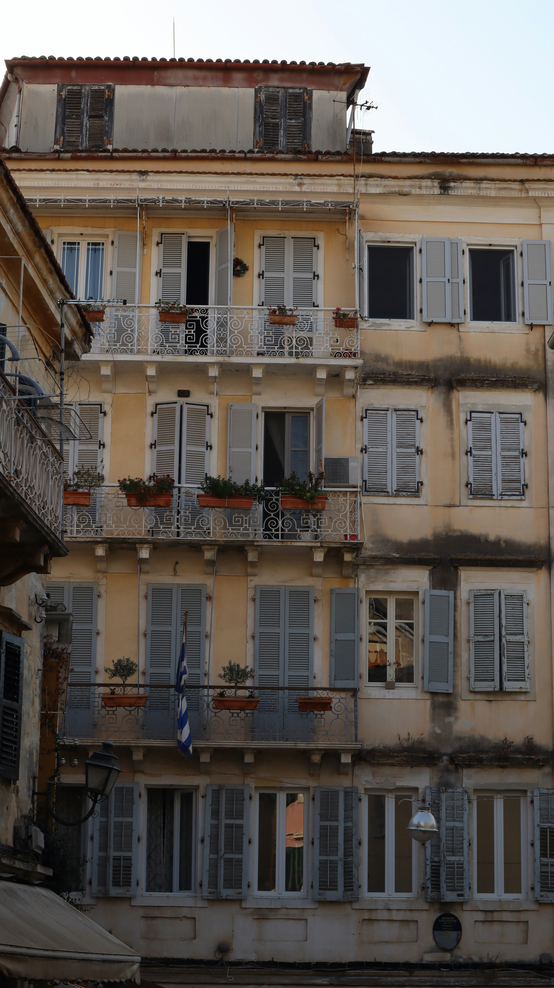 Venetian-style building with shutters and flower balconies in Corfu Old Town