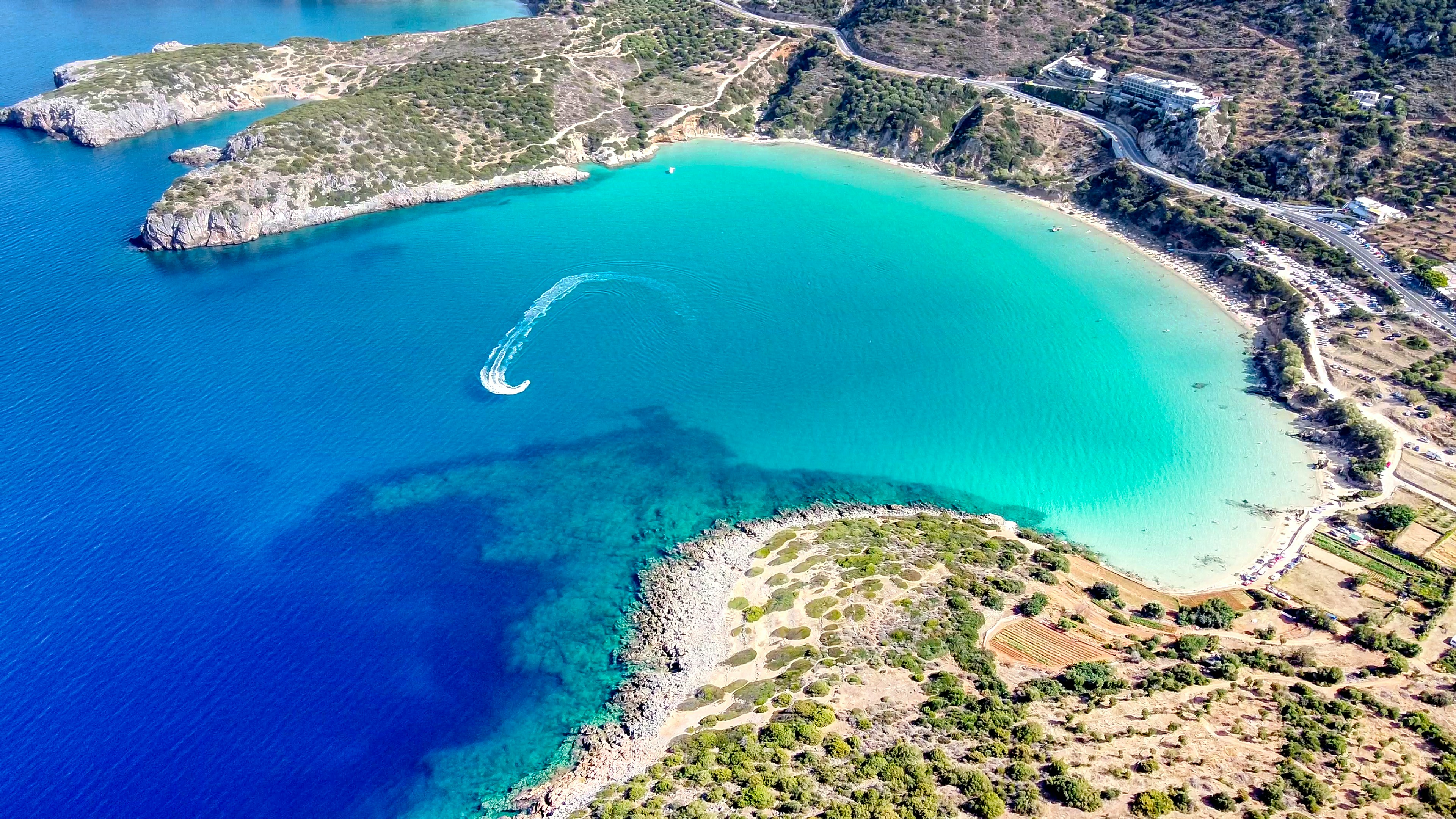Aerial view of a turquoise cove beach in Crete, Greece