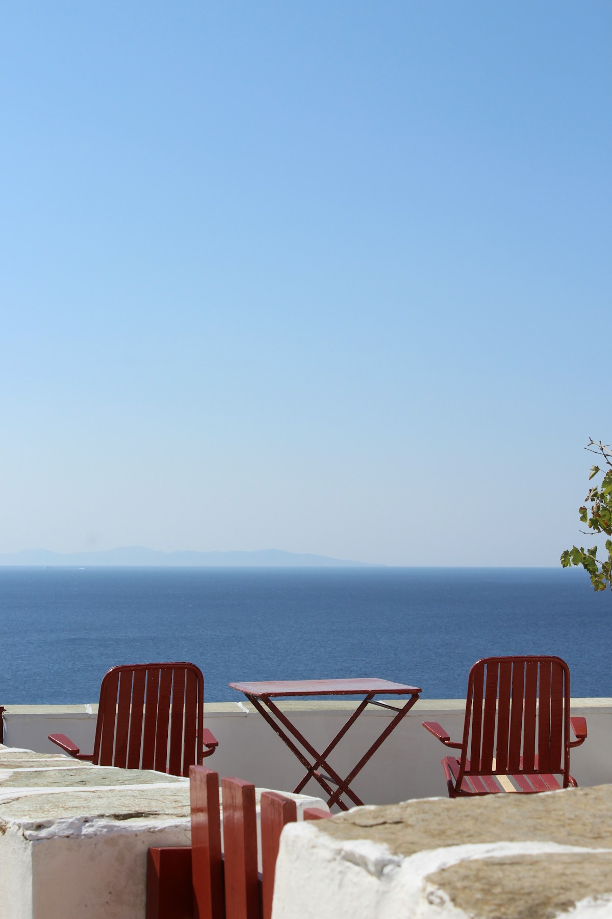 Outdoor taverna terrace with sea view in Ios Chora at sunset, Greek islands