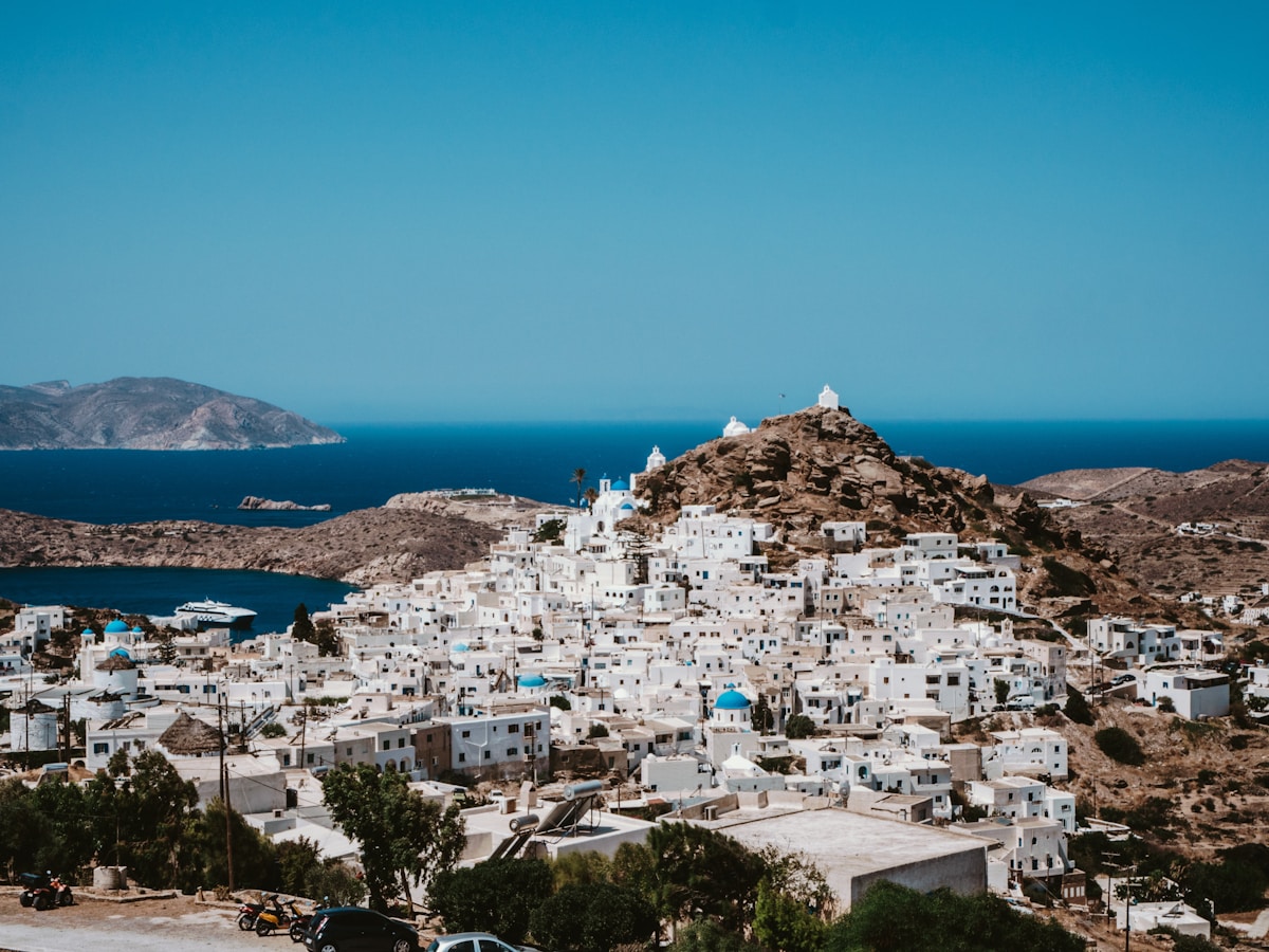 The whitewashed hilltop village of Chora on Ios island, Greece, with windmills above