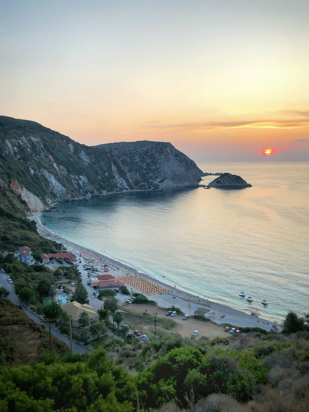 Myrtos Beach in Kefalonia with white pebbles and turquoise water surrounded by steep cliffs