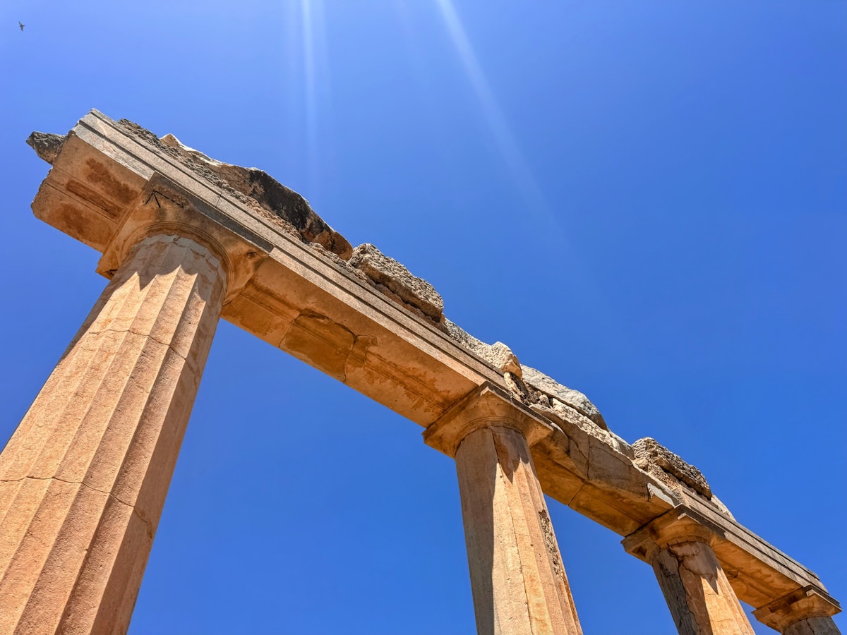 Ancient columns of the Asklepion ruins on Kos island with turquoise sea in the background