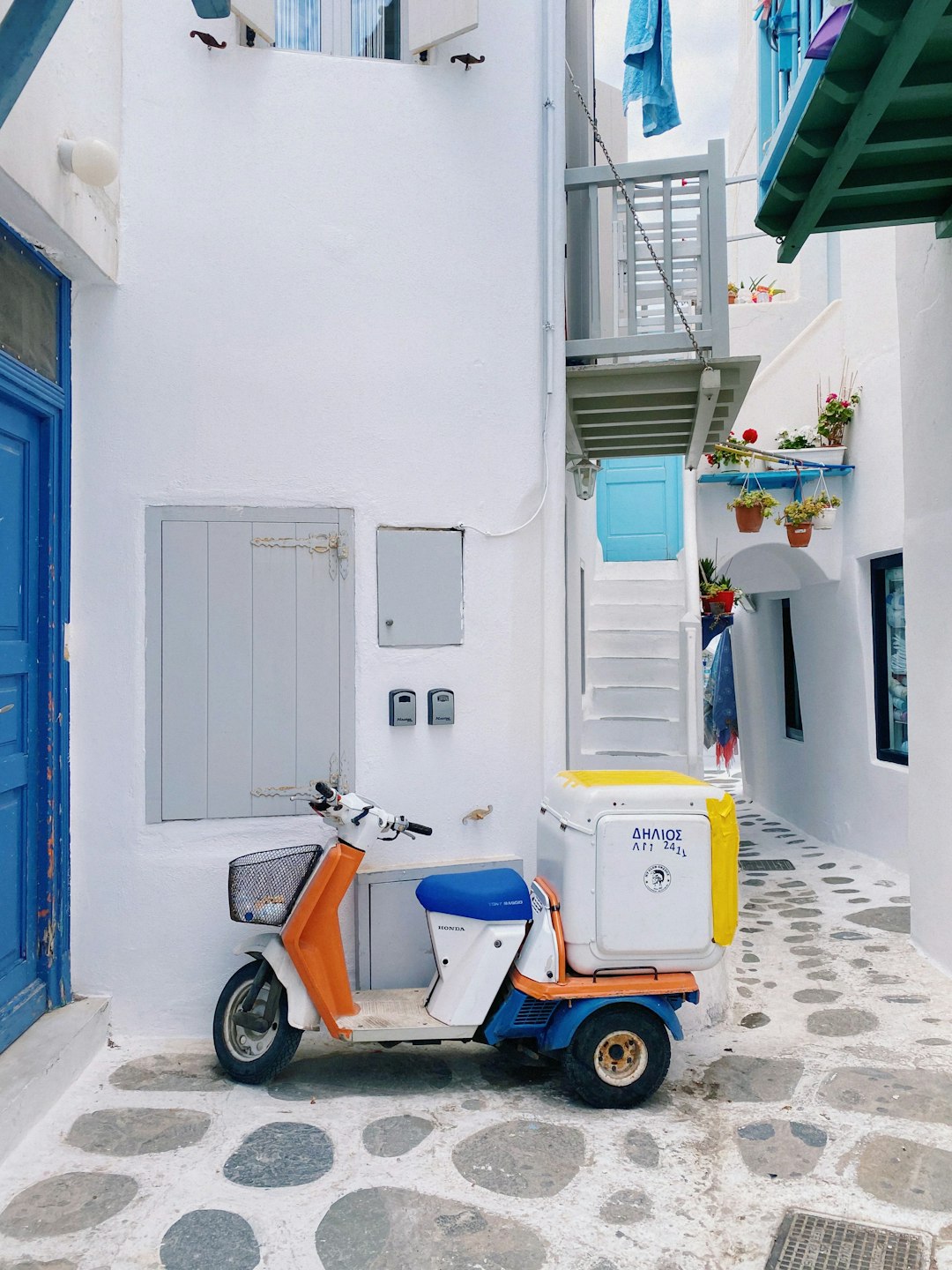 Scooter parked in a narrow whitewashed alleyway, Mykonos, Greece