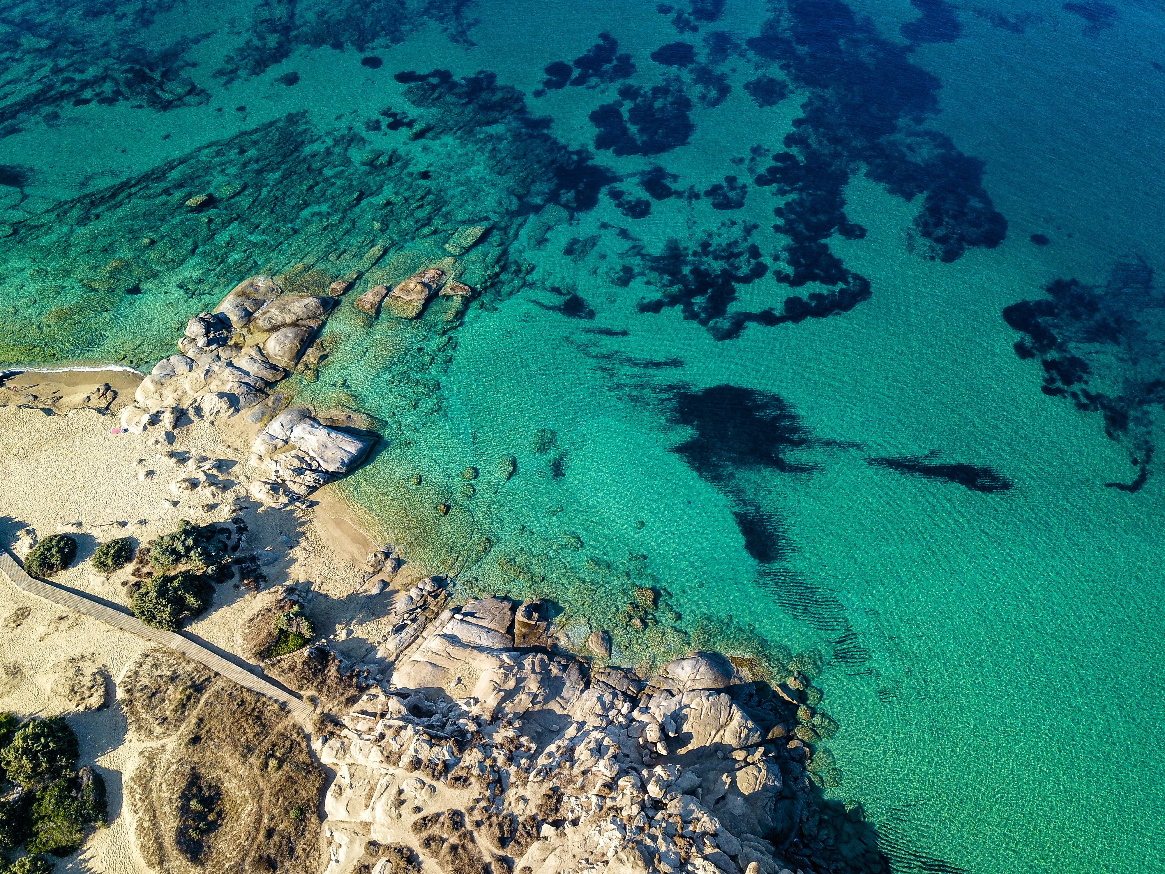 Long stretch of sandy beach with turquoise water at Plaka, Naxos