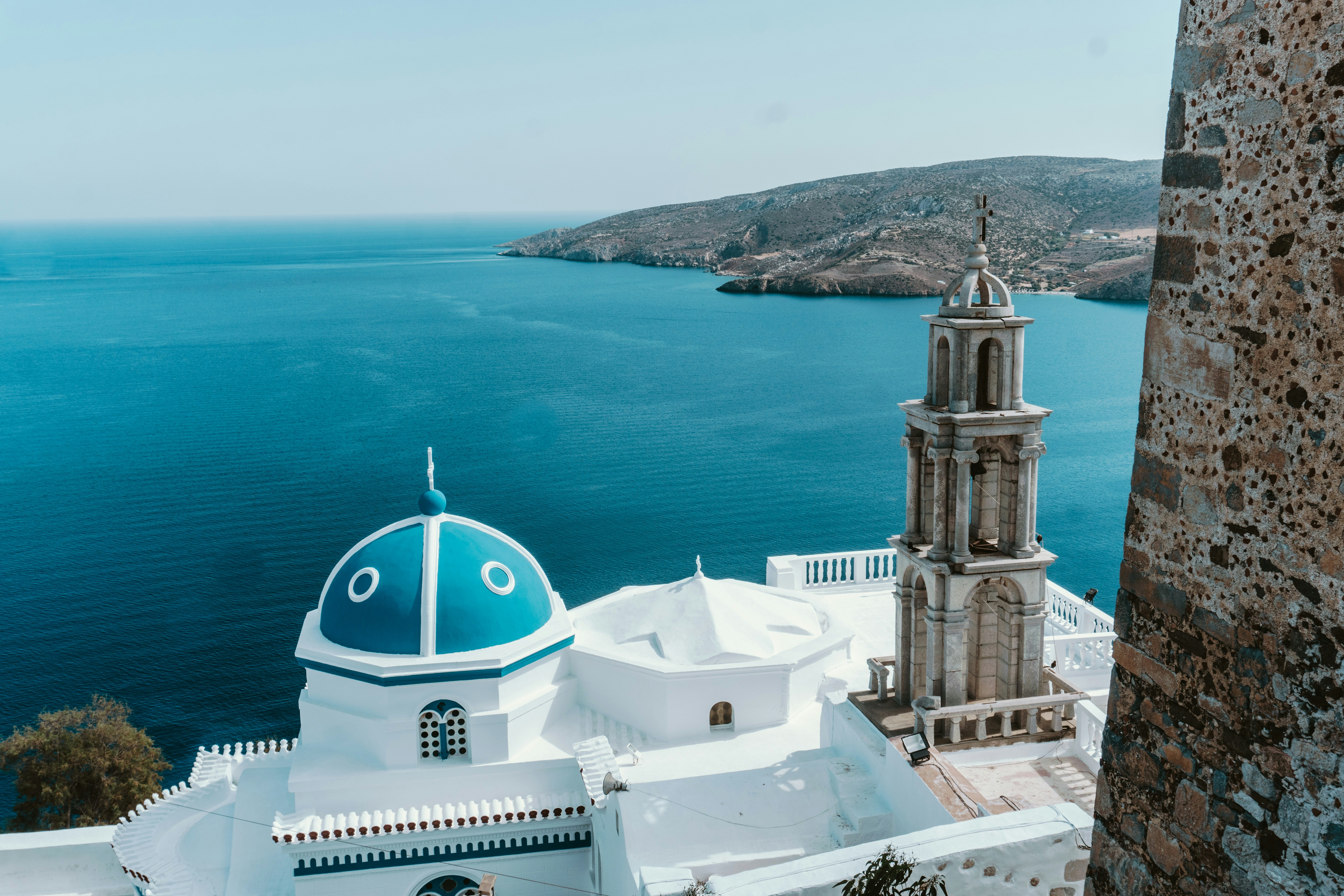 White church with blue dome and belltower overlooking the Aegean Sea, Dodecanese, Greece
