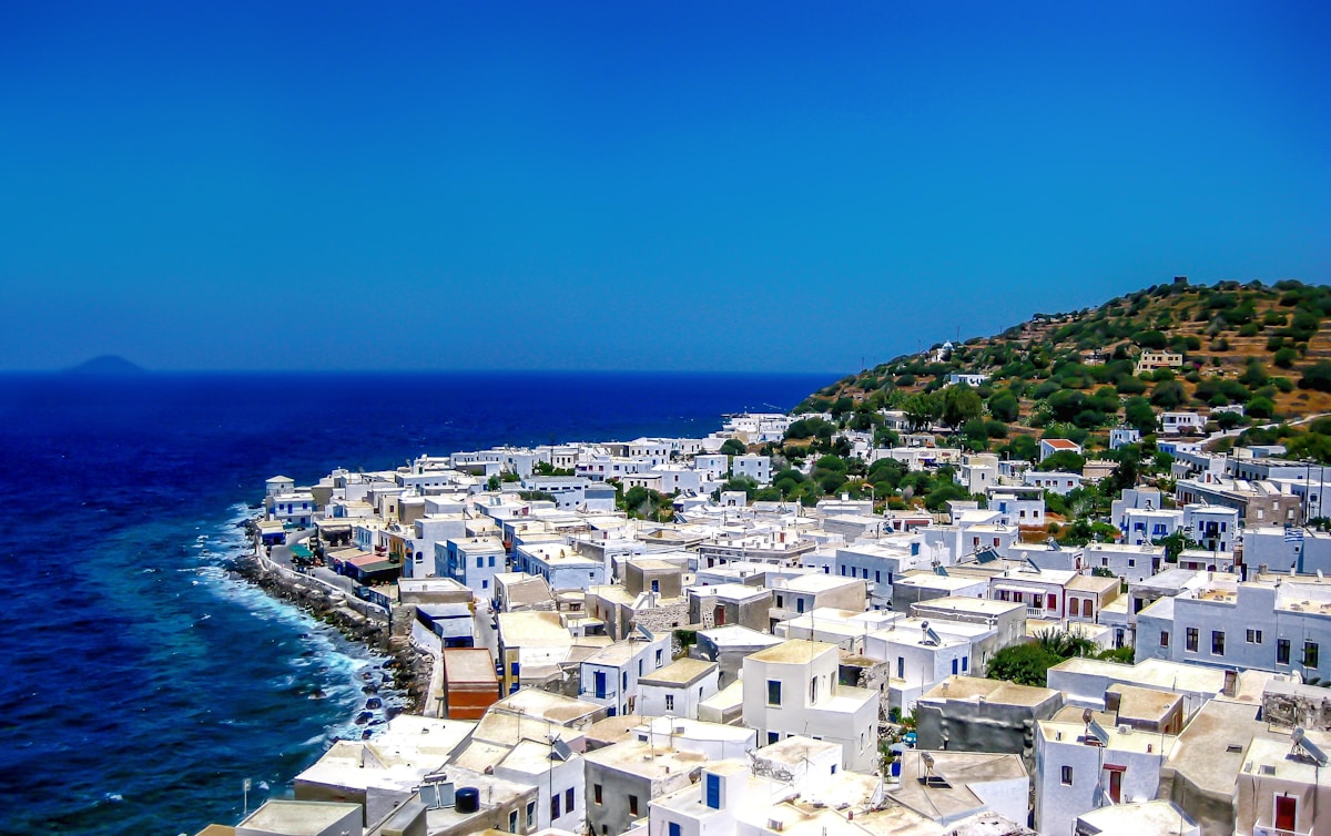 White-washed village of Nisyros island built on volcanic hillside above the blue Aegean Sea, Dodecanese, Greece