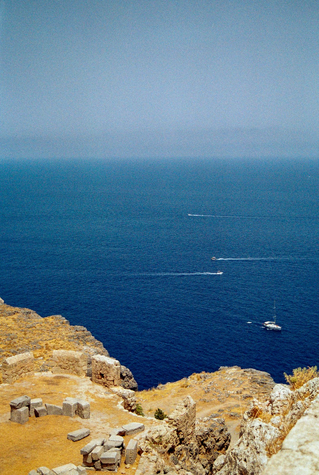 Ancient ruins of Lindos Acropolis overlooking the deep blue sea, Rhodes, Greece