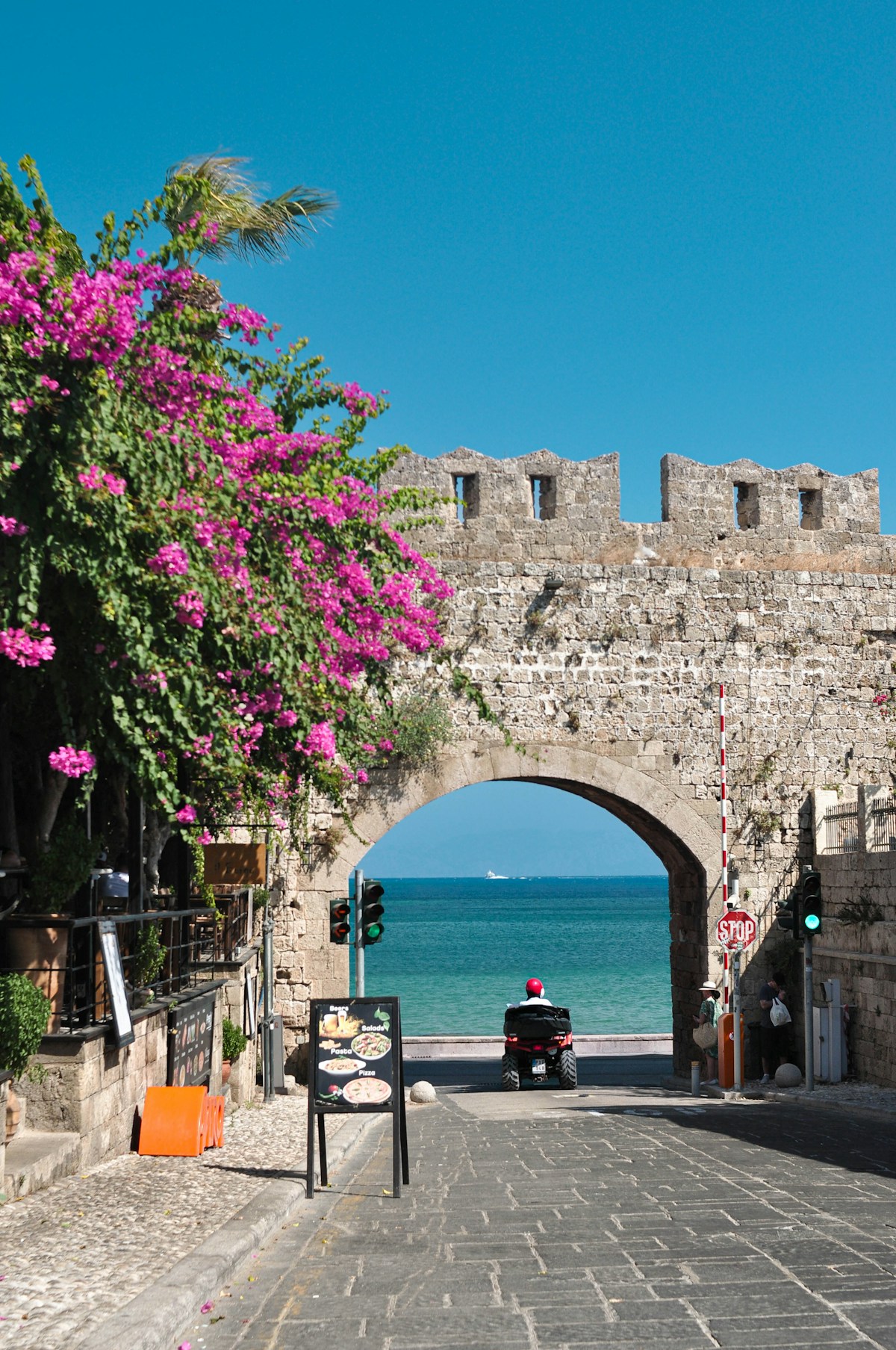 Garden courtyard restaurant in Rhodes Old Town with stone walls and candles