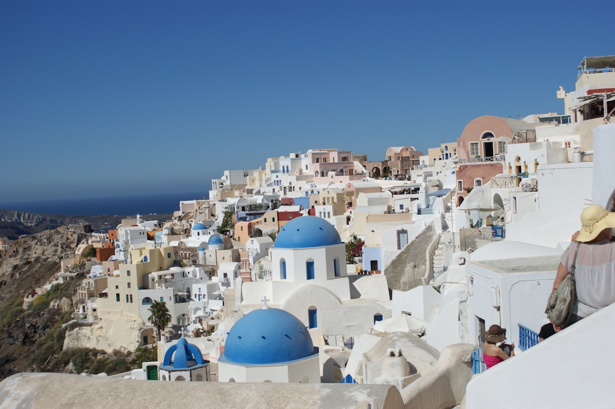 White-washed buildings with blue domes overlooking the Santorini caldera