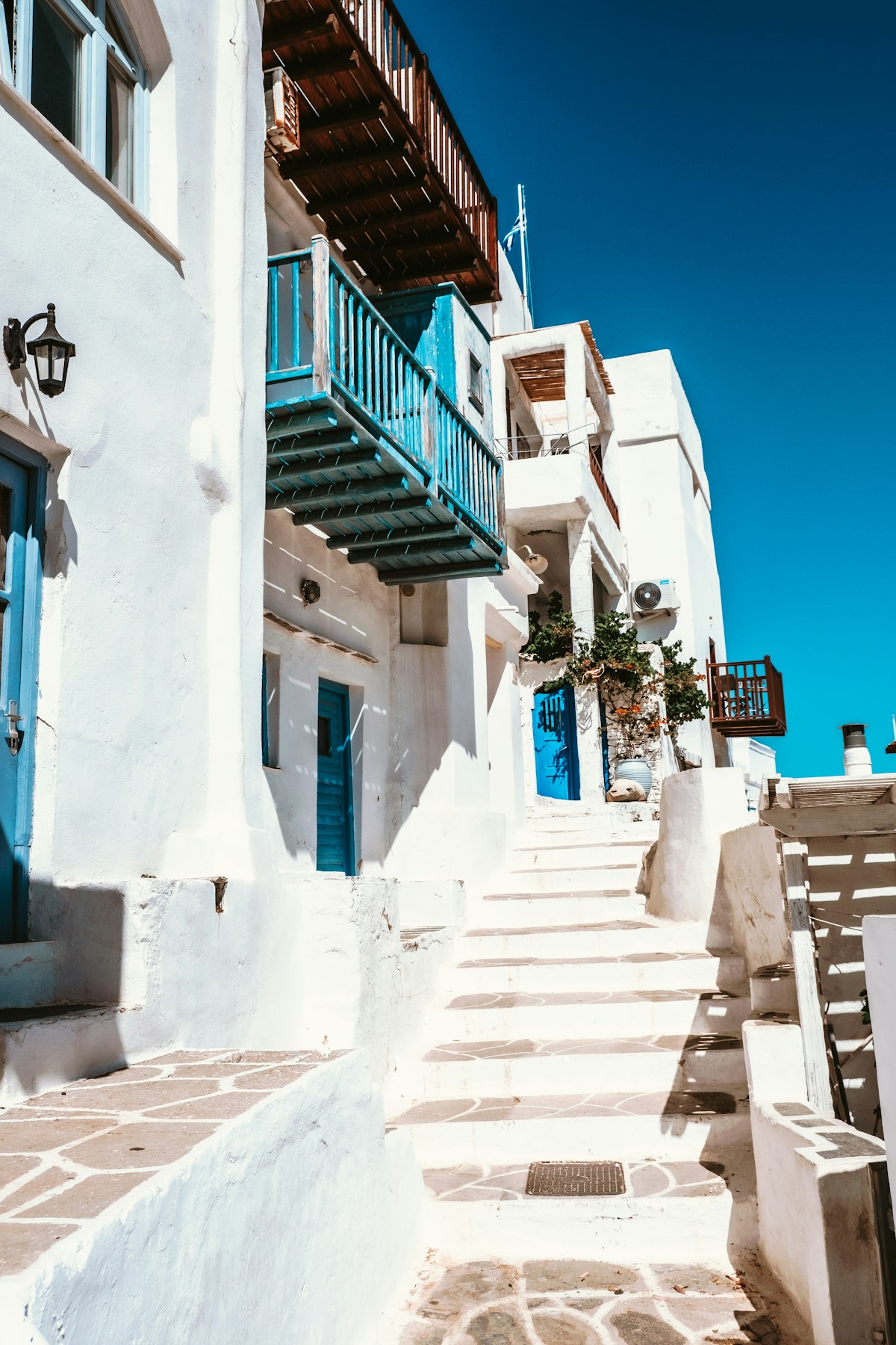Whitewashed stone stairs and blue-painted balconies in Kastro village, Sifnos, Cyclades, Greece