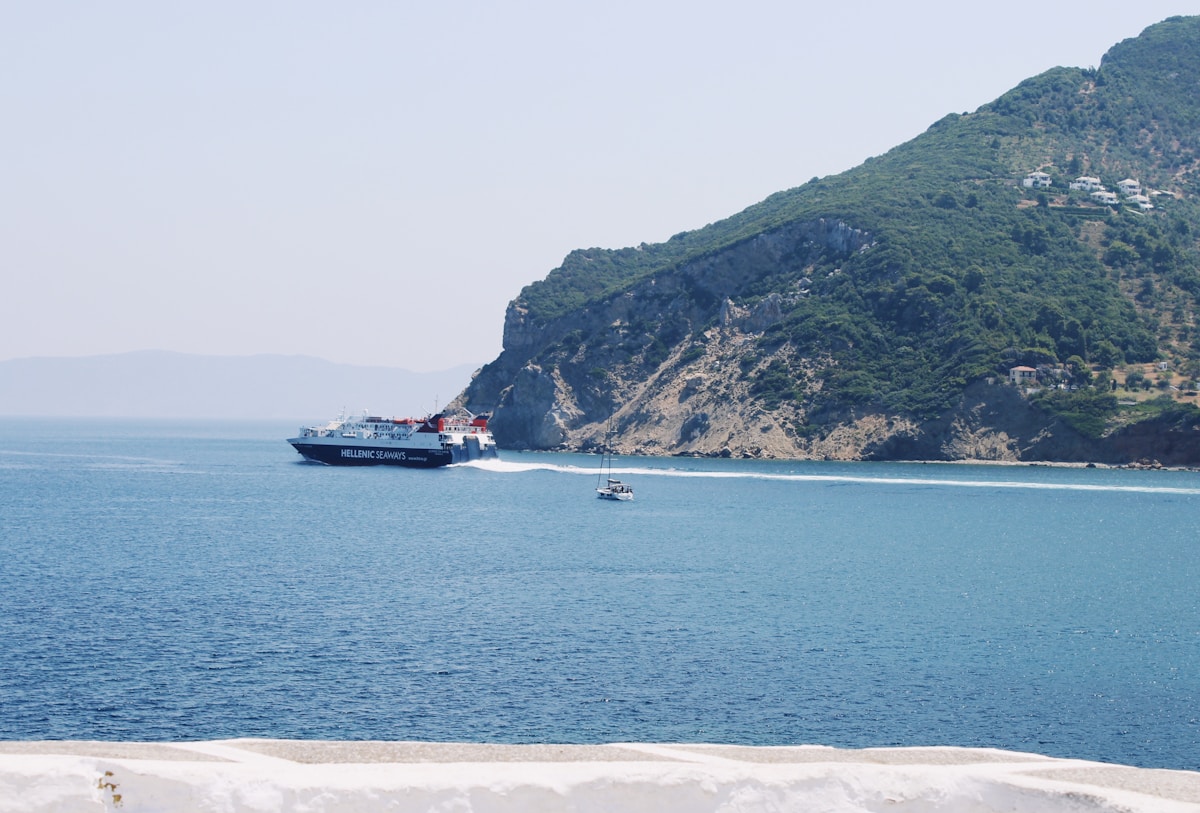 Hellenic Seaways high-speed ferry approaching Skopelos through pine-covered mountains, Greece