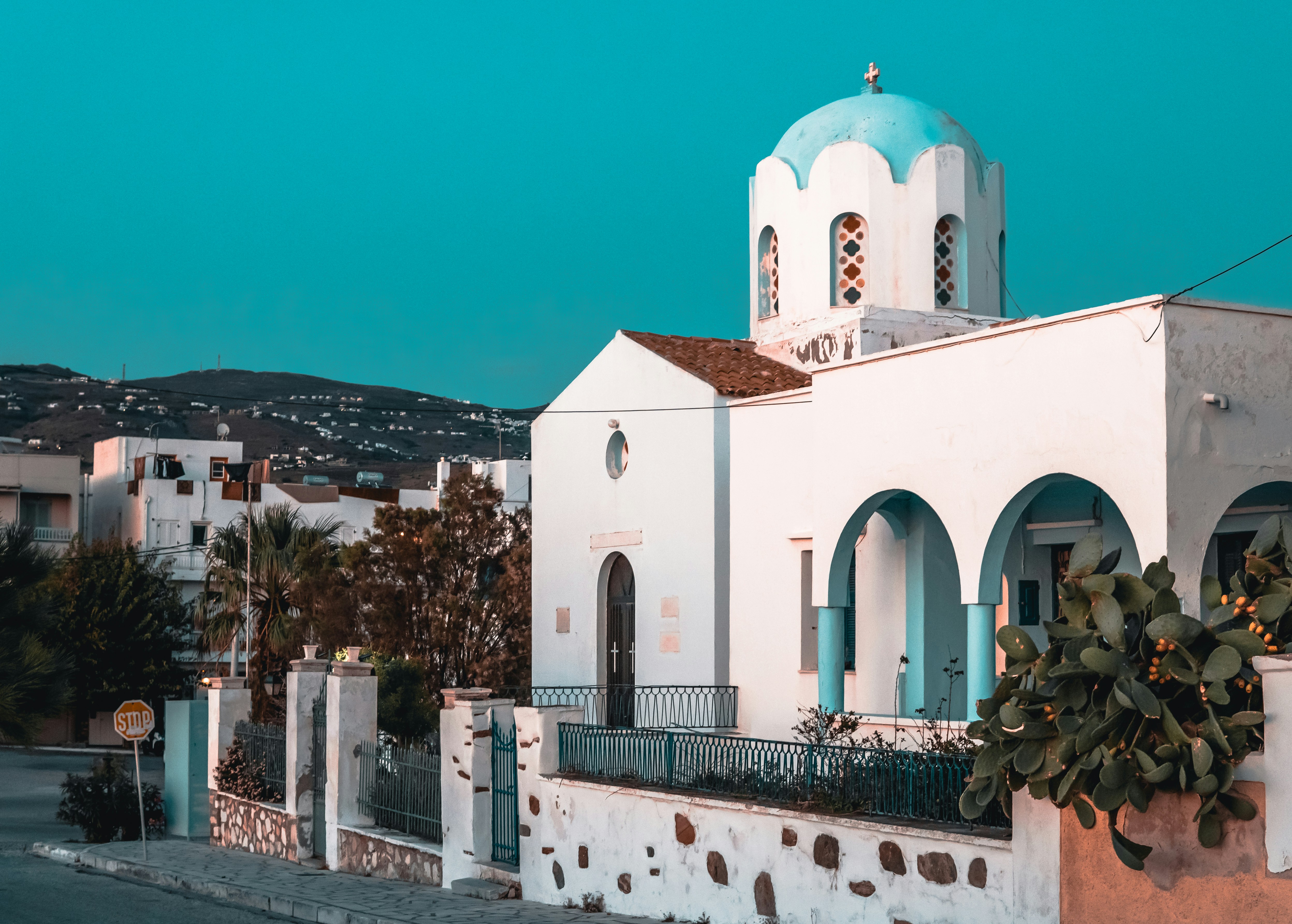 White church with blue dome and cactus garden, Tinos island, Cyclades, Greece