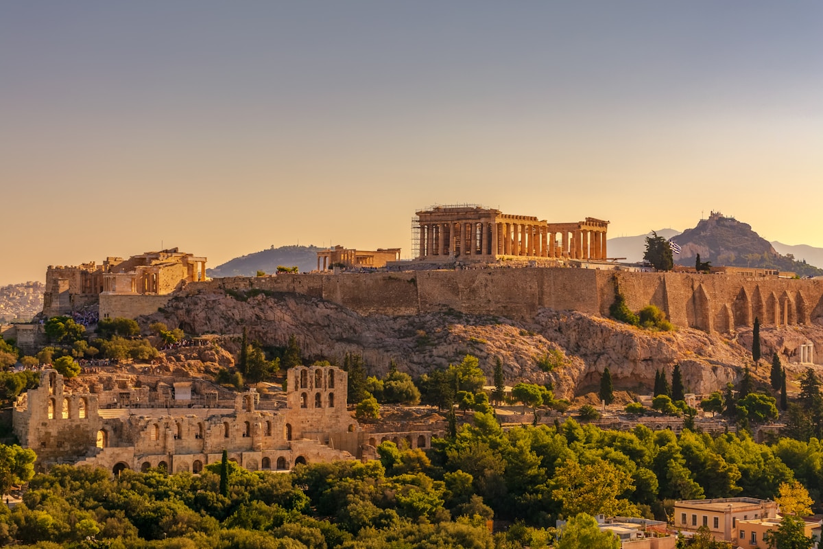 Acropolis of Athens at golden hour with the Parthenon above the Odeon of Herodes Atticus