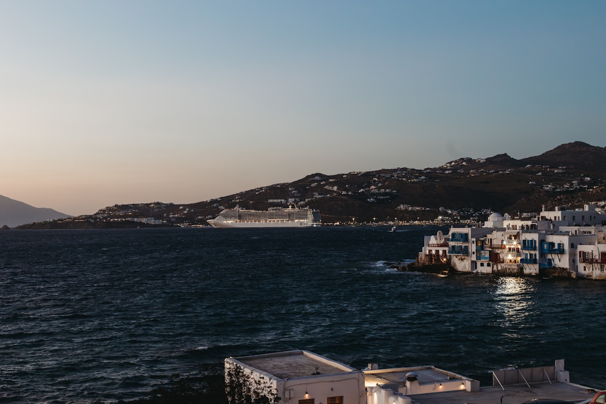 Large cruise ship anchored off Little Venice waterfront, Mykonos, Greece