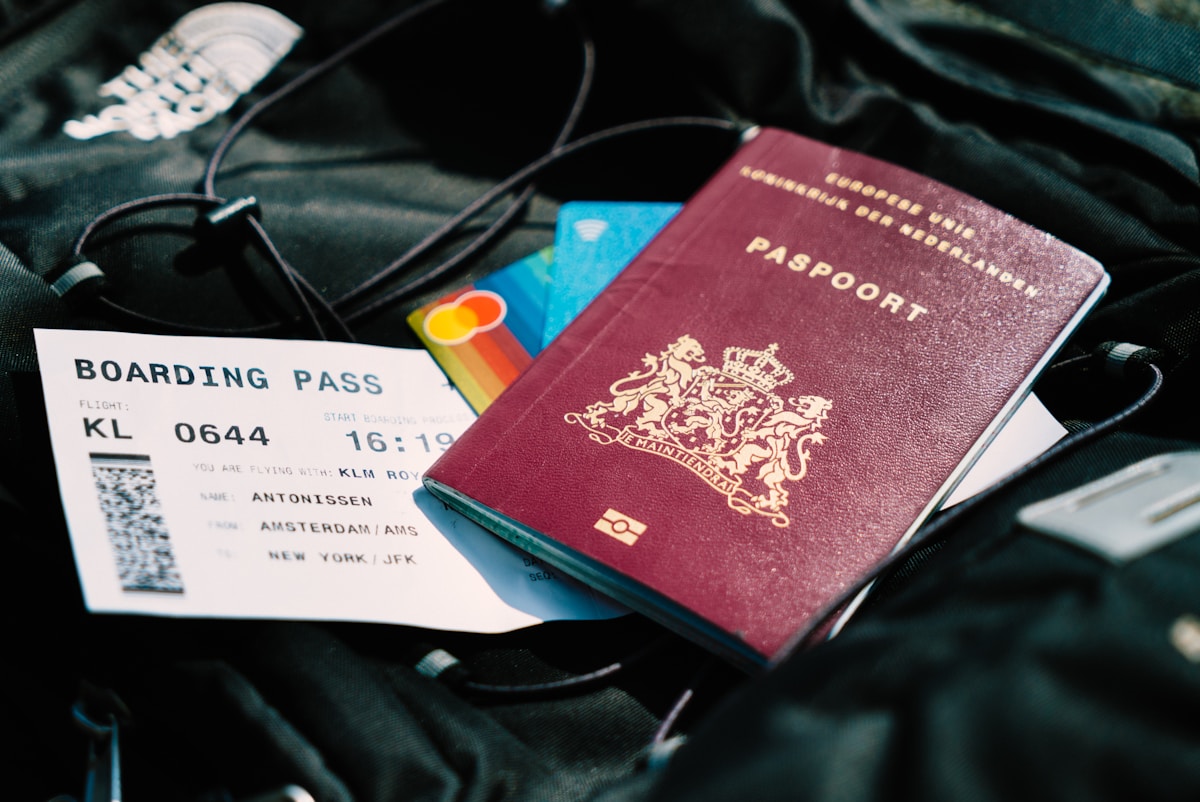 Passport and boarding pass resting on a travel bag at an international airport