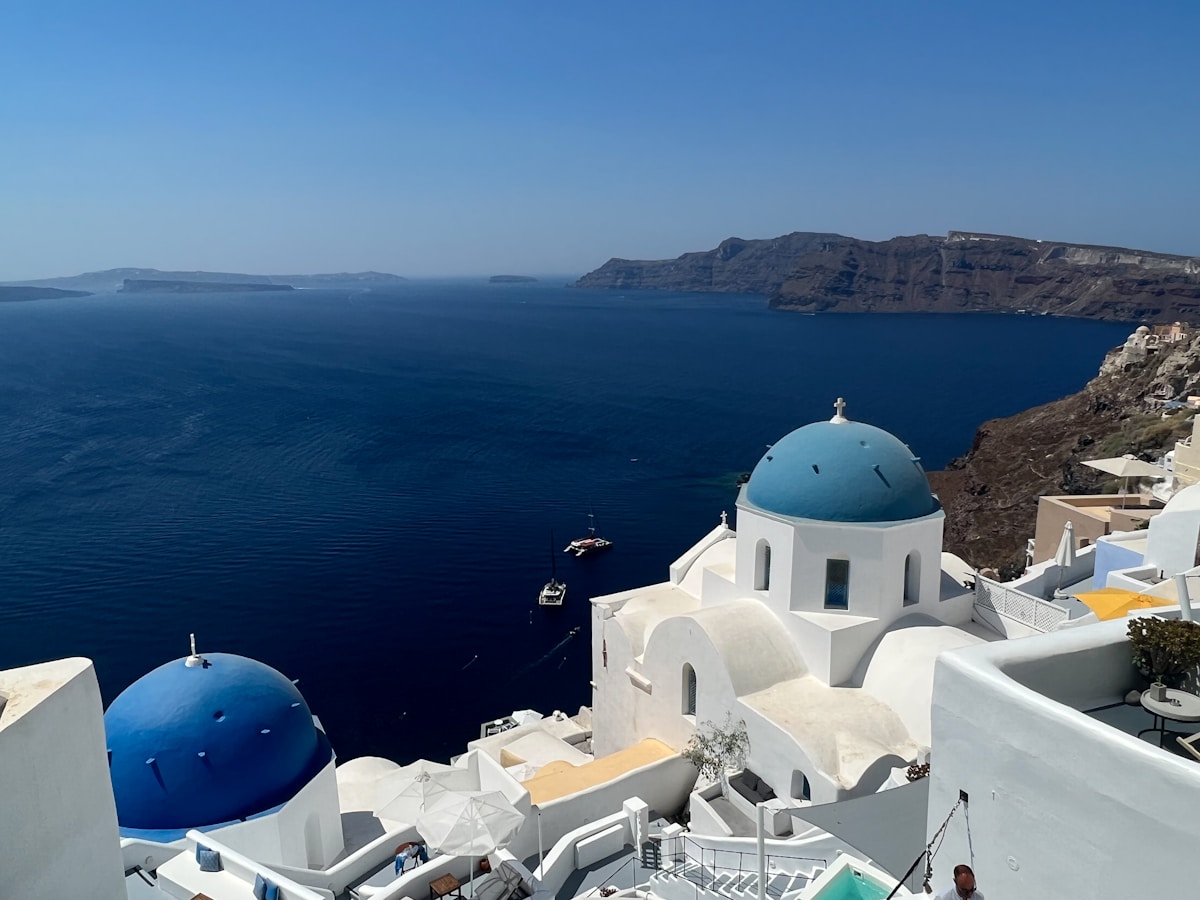 Blue-domed churches overlooking the Santorini caldera and Aegean Sea, Greece