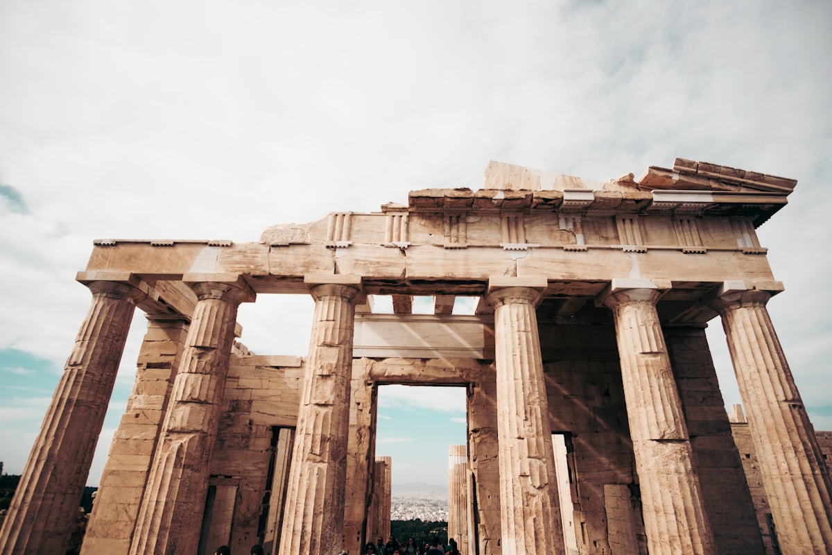 Parthenon columns viewed from below against cloudy sky, Athens, Greece