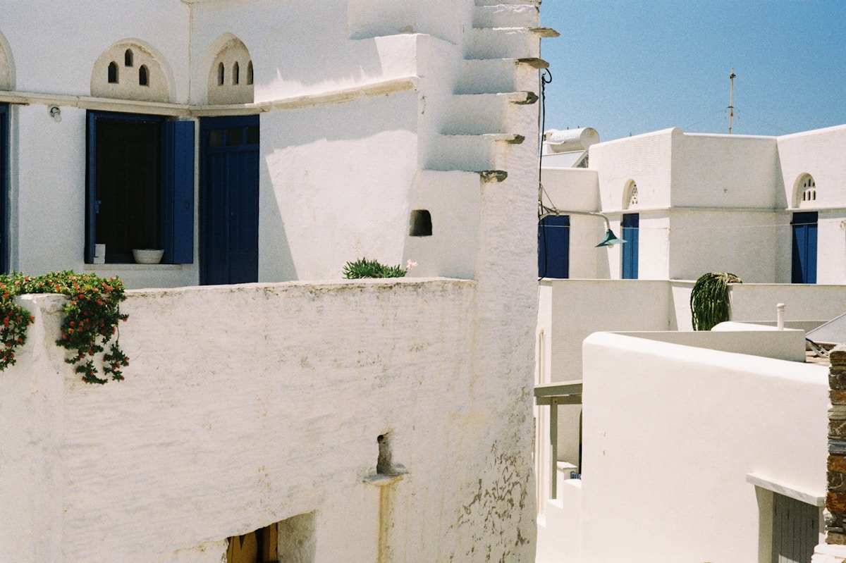 Sunny Greek island panorama with blue sky and whitewashed village overlooking the Aegean Sea