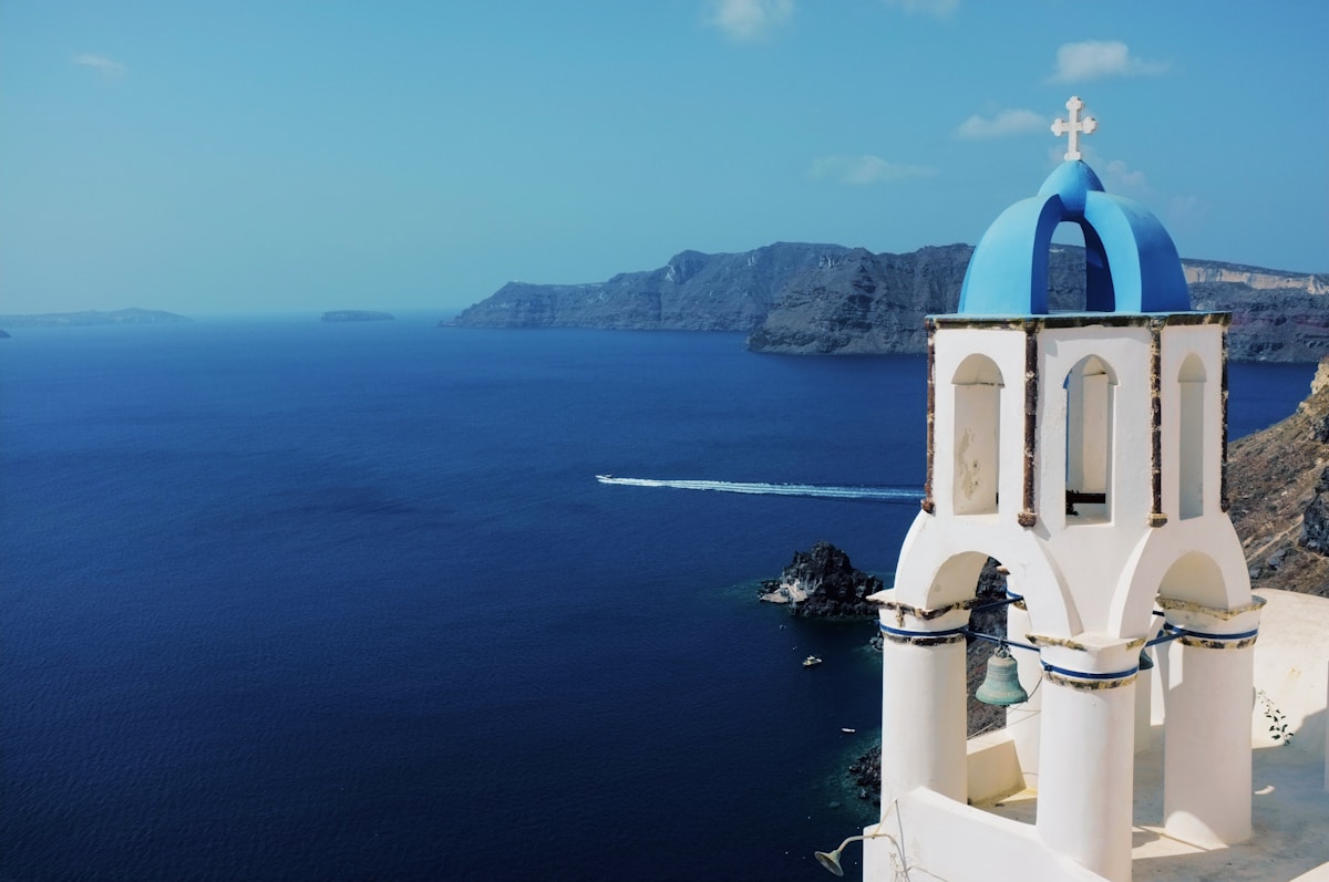 Blue-domed church overlooking the Santorini caldera and sea