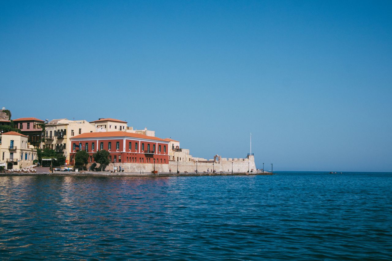 Chania harbour waterfront with the Venetian lighthouse bastion and neoclassical buildings, Crete