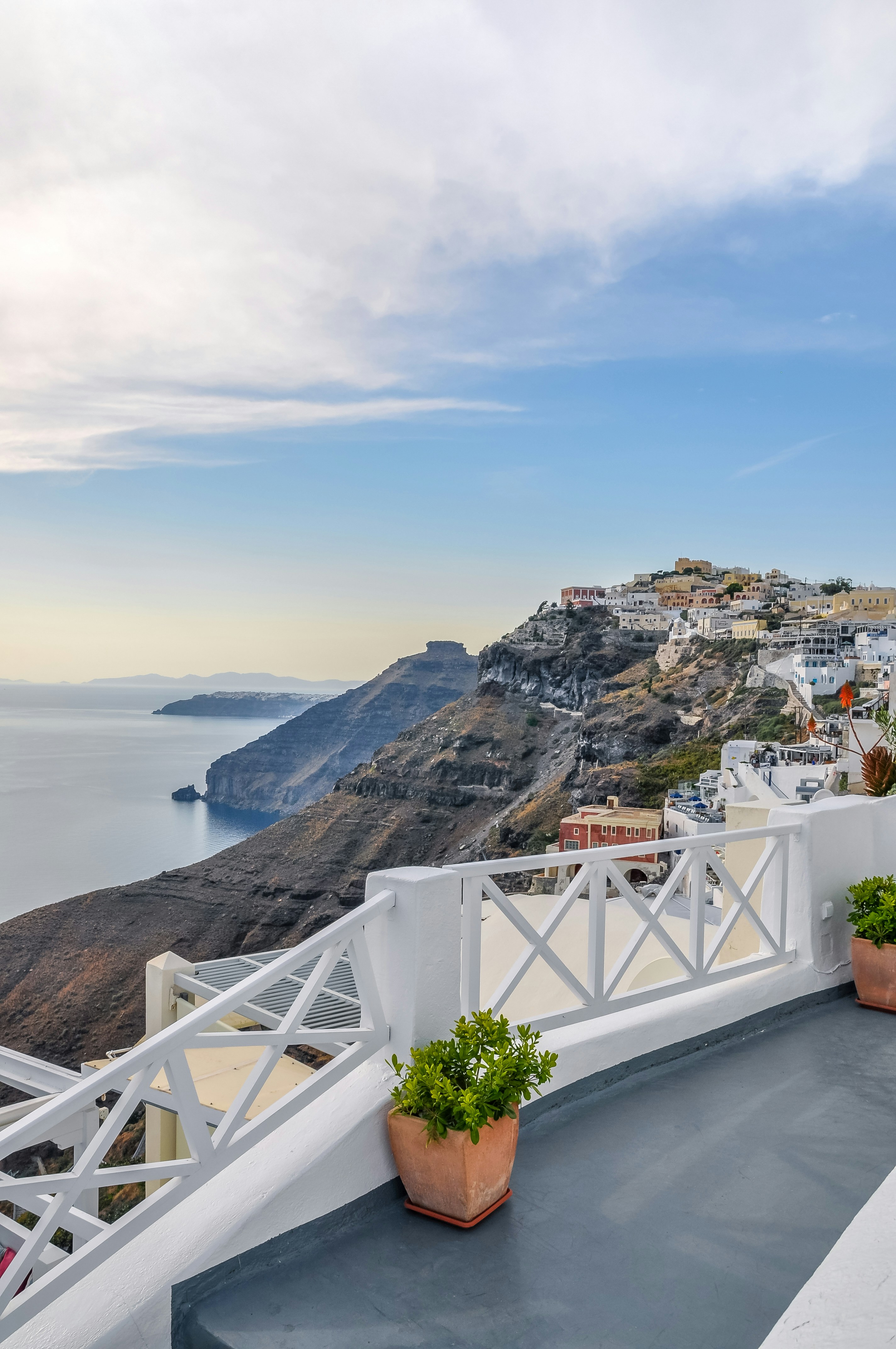White railing terrace overlooking the Santorini caldera and Aegean Sea
