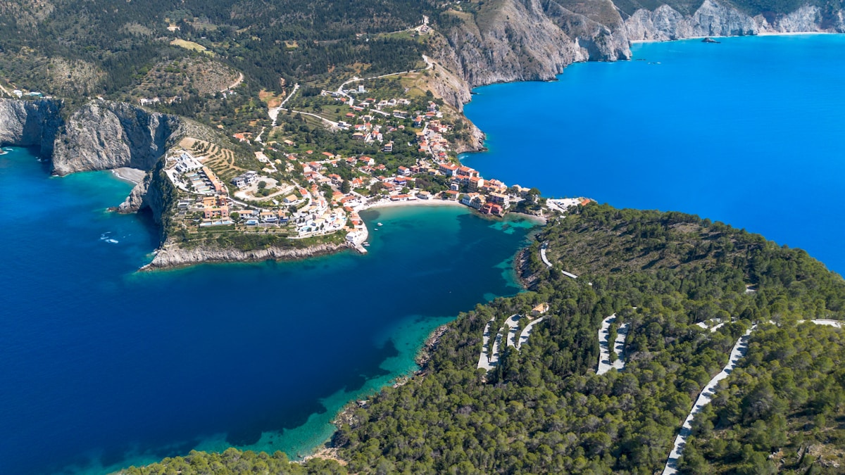 Aerial view of Assos village on a peninsula surrounded by turquoise water, Kefalonia, Greece