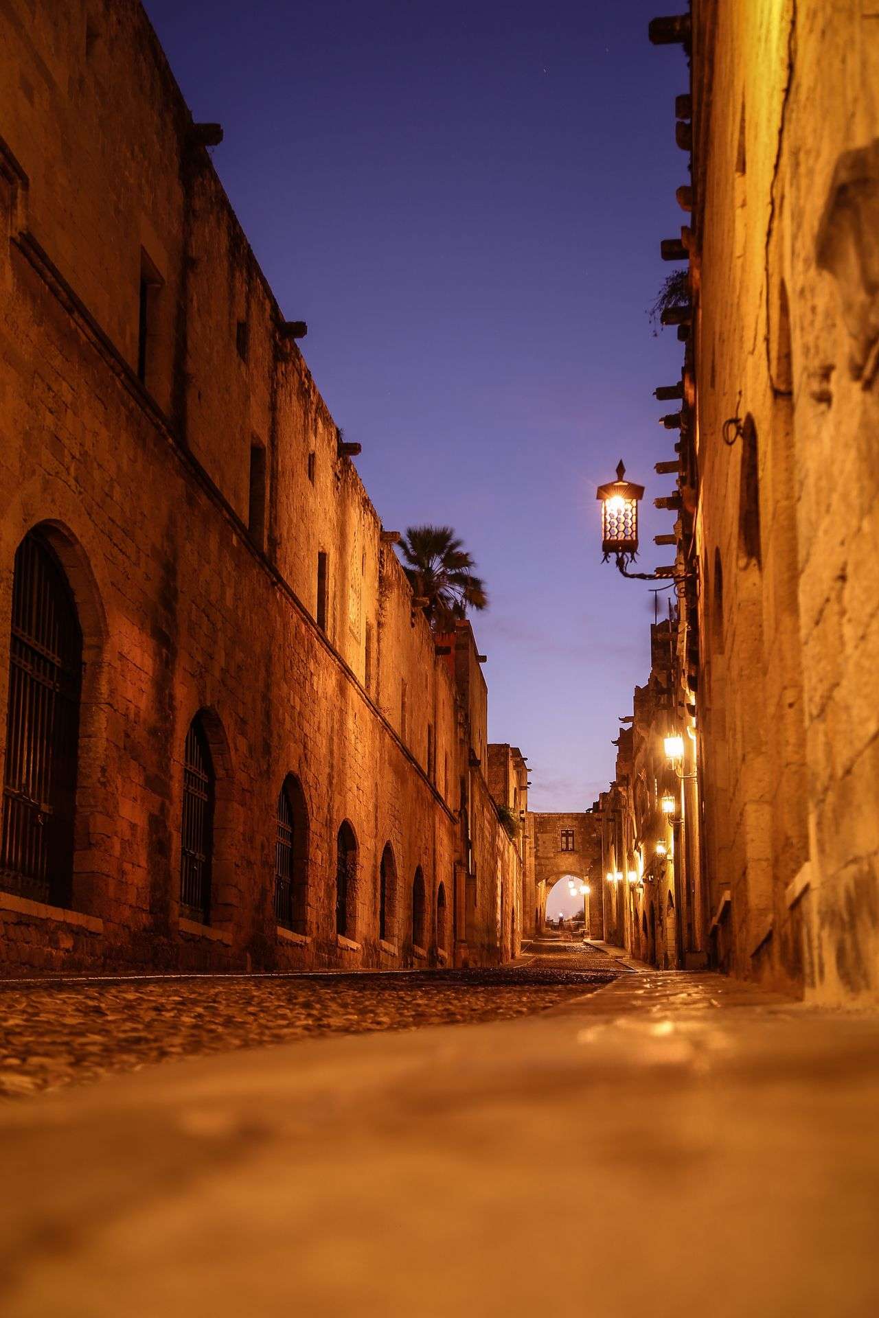 Street of the Knights in Rhodes Old Town at dusk with warm lanterns, Greece