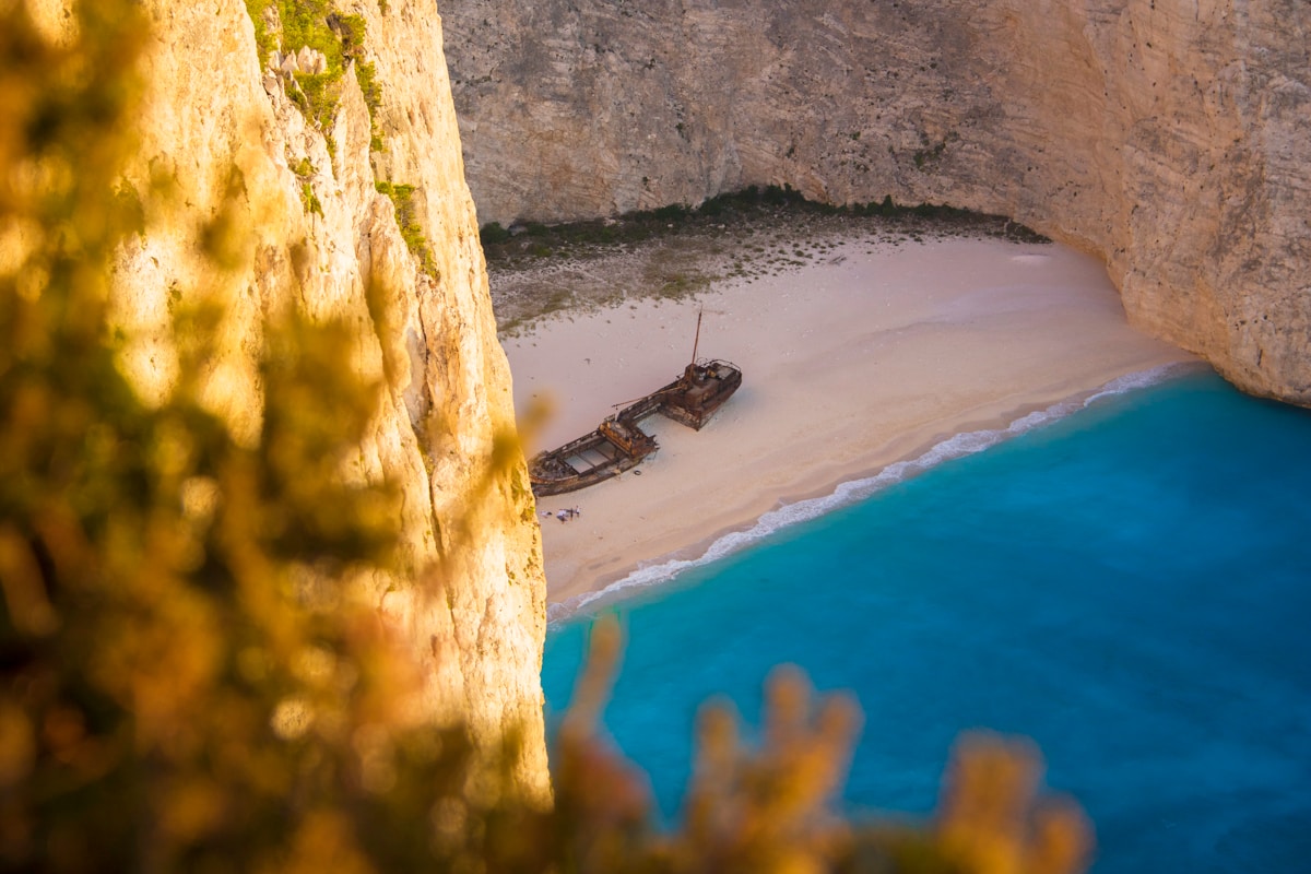Aerial view of Navagio Shipwreck Beach with rusty ship on white sand and turquoise water, Zakynthos, Greece