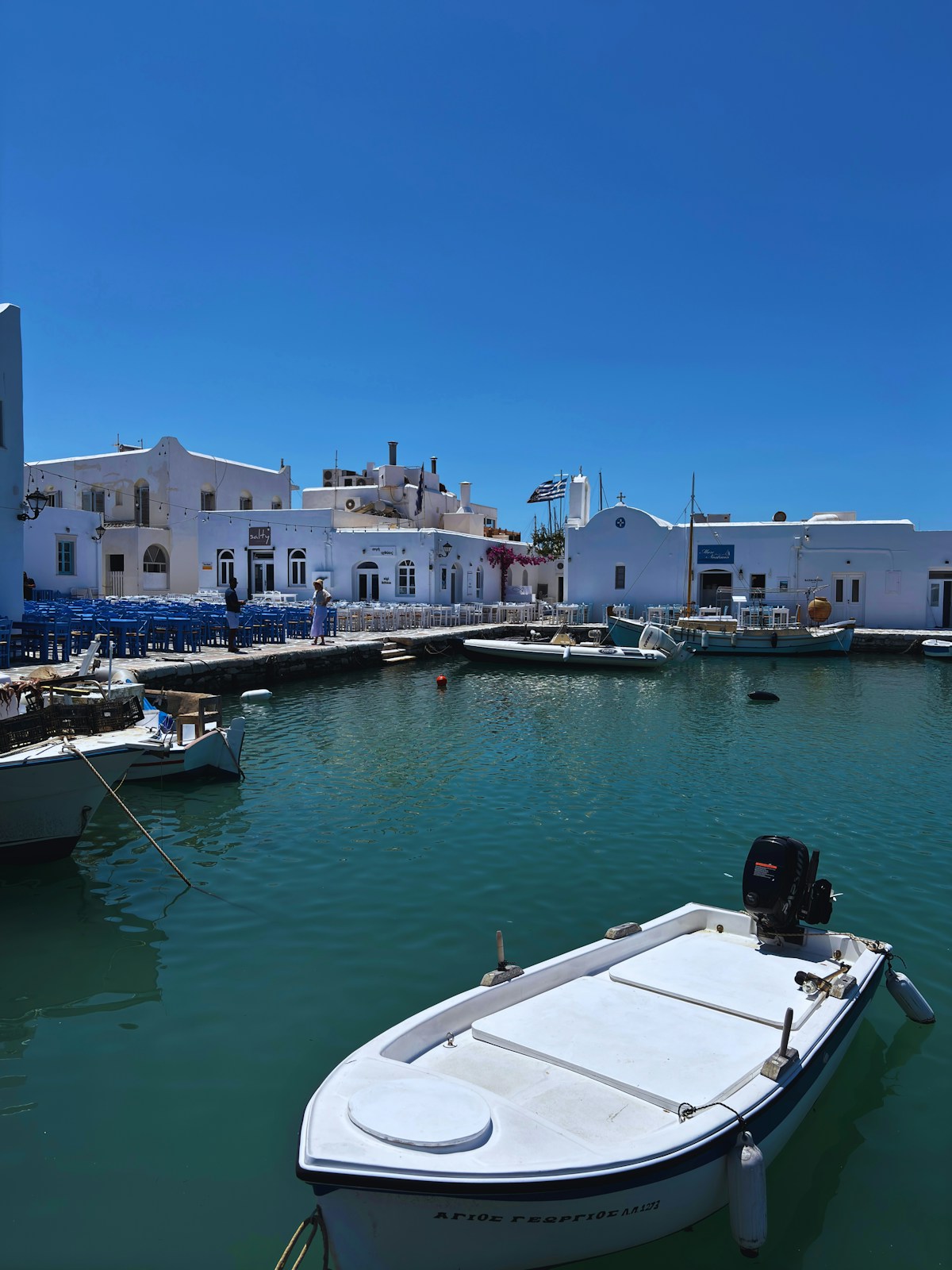 Fishing boats and waterfront restaurants in the harbour at Naoussa, Paros
